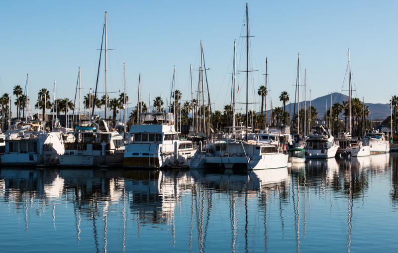 Boats moored in bay at the Chula Vista Bayfront park with mountain peak in the background.