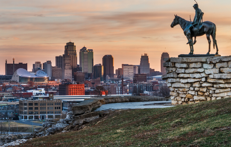 Kansas City, Missouri, USA on March 22, 2014. A image of the Kansas City Scout overlooking Kansas City at sunrise. The Indian Scout is known as a Kansas City landmark and symbol of the city.