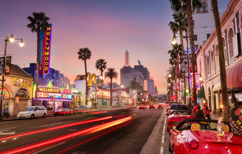 LOS ANGELES, CALIFORNIA - MARCH 1, 2016: Traffic on Hollywood Boulevard at dusk. The theater district is a famous tourist attraction.