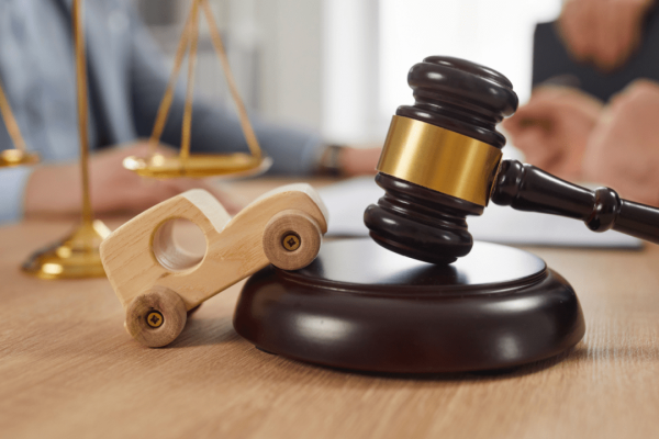 A car accident victim and attorney review a settlement offer in a legal office, discussing compensation for injuries and losses