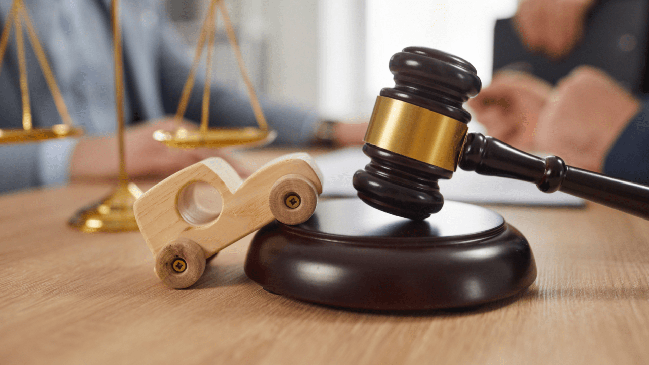 A car accident victim and attorney review a settlement offer in a legal office, discussing compensation for injuries and losses
