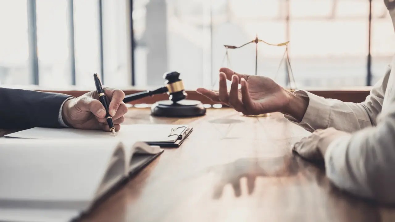 Personal injury attorney and client discussing settlement timeline after completing physical therapy.