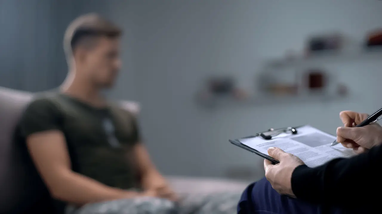 Attorney reviewing PTSD settlement paperwork with a client in a private legal consultation.