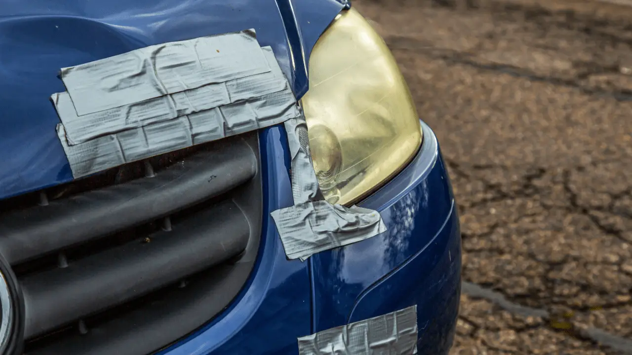 A client and insurance agent review a minor car accident claim and repair estimate in an office setting