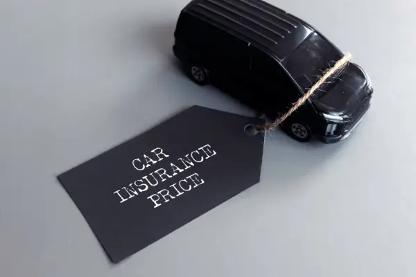 Car Insurance price tag attached to a black toy car