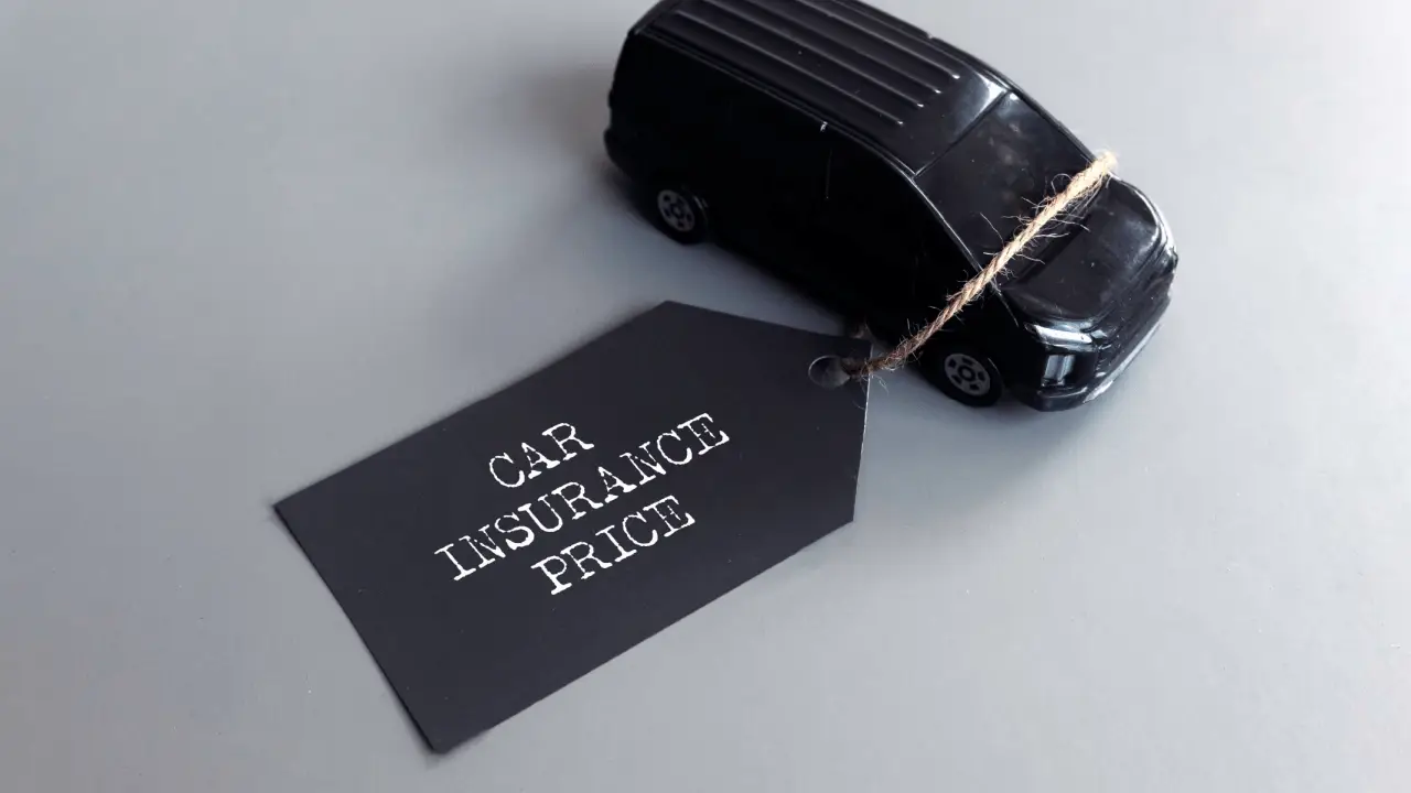 Car Insurance price tag attached to a black toy car
