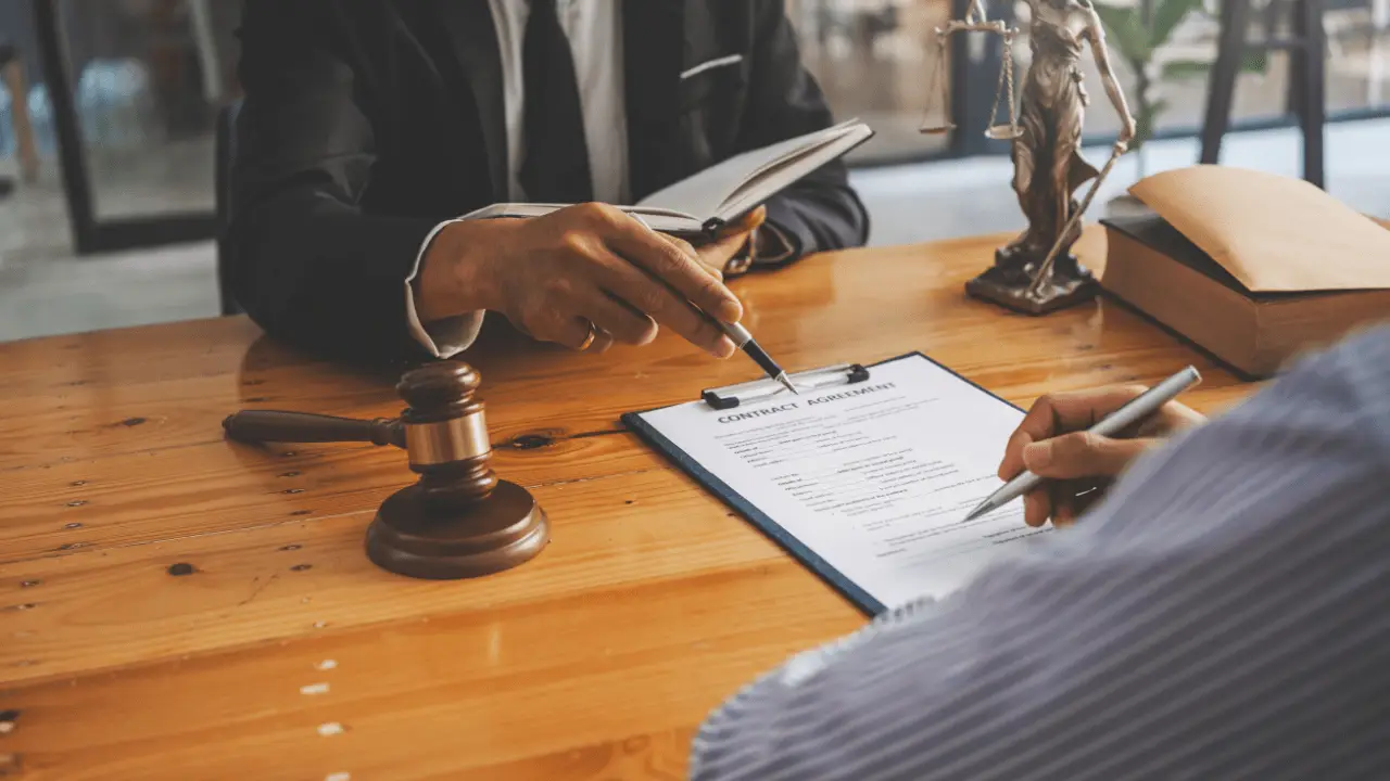 A client and attorney review a settlement disbursement summary showing deductions for fees, liens, and final payout How much of a settlement do you actually get