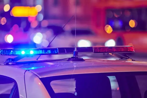 Texas drivers at the scene of a car accident with police and insurance forms visible