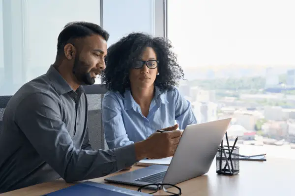 Couple using car accident settlement calculator Georgia tool on laptop to estimate claim value