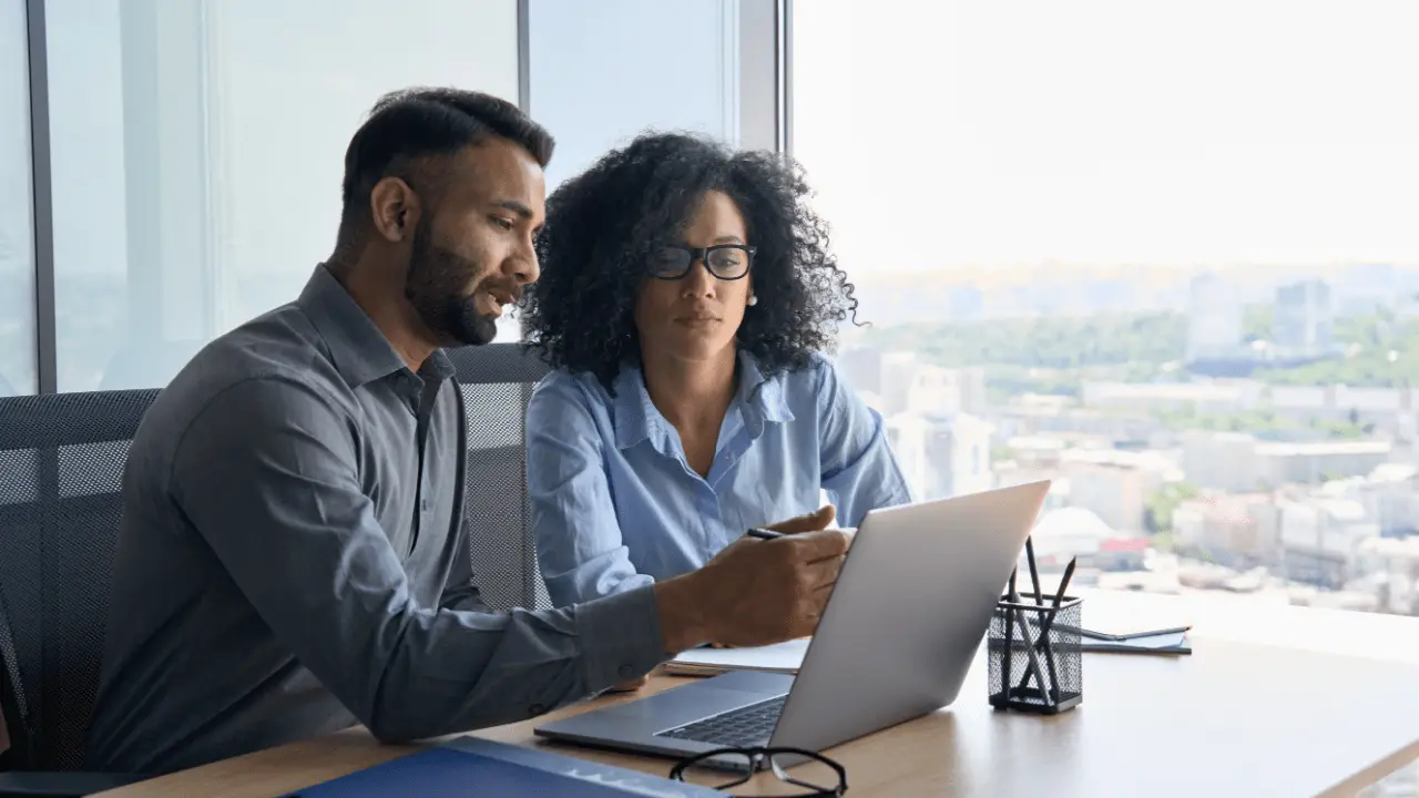 Couple using car accident settlement calculator Georgia tool on laptop to estimate claim value