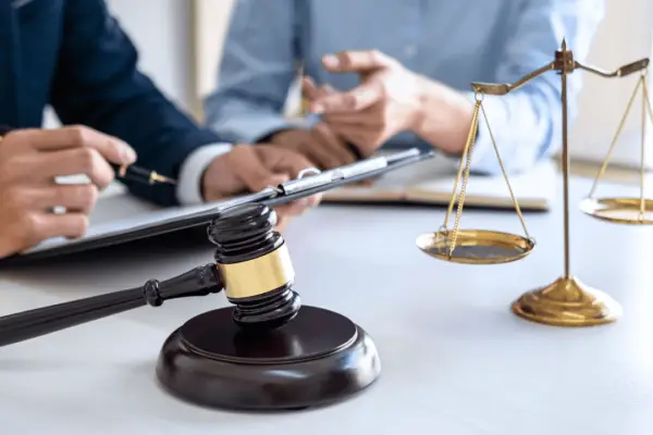Car accident settlement lawyers discussing timeline with gavel and scales of justice on desk