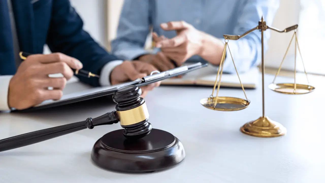 Car accident settlement lawyers discussing timeline with gavel and scales of justice on desk