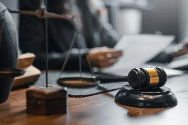 Close-up of gavel and justice scale on lawyer’s desk — what are the odds of winning a lawsuit?