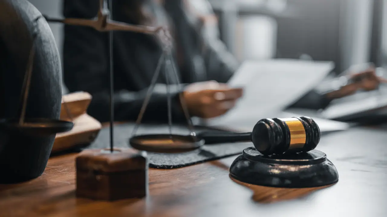 Close-up of gavel and justice scale on lawyer’s desk — what are the odds of winning a lawsuit?