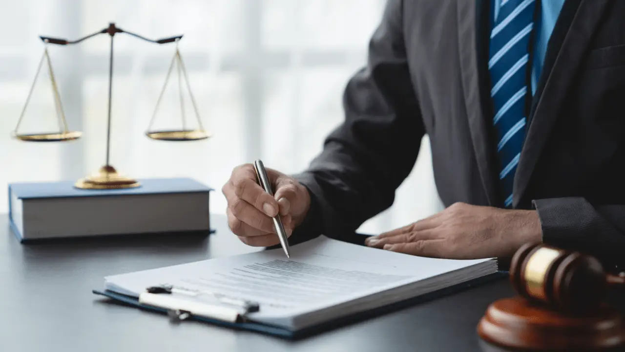 Attorney reviewing legal documents do insurance companies pay attorney fees consultation scales of justice