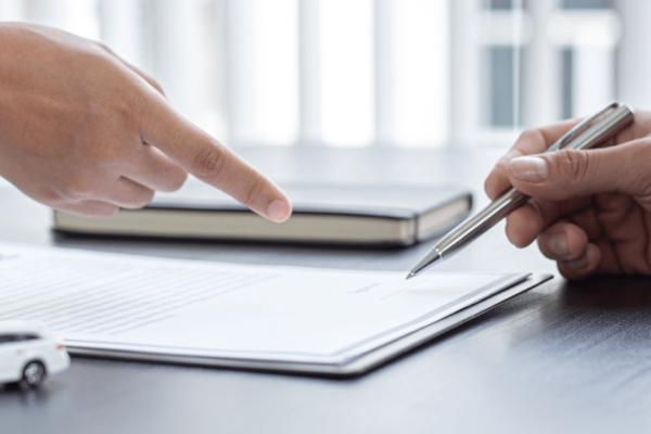 Lawyer reviewing insurance policy documents to determine how much does a lawyer pay for insurance coverage