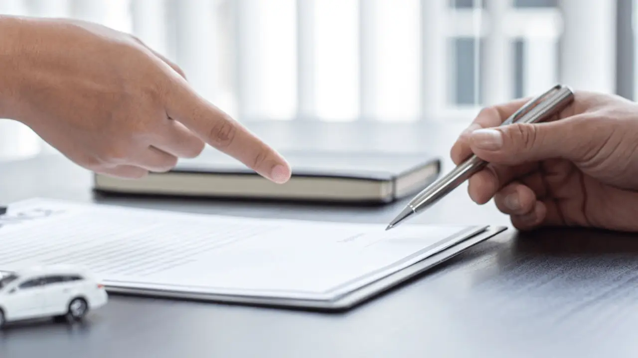 Lawyer reviewing insurance policy documents to determine how much does a lawyer pay for insurance coverage