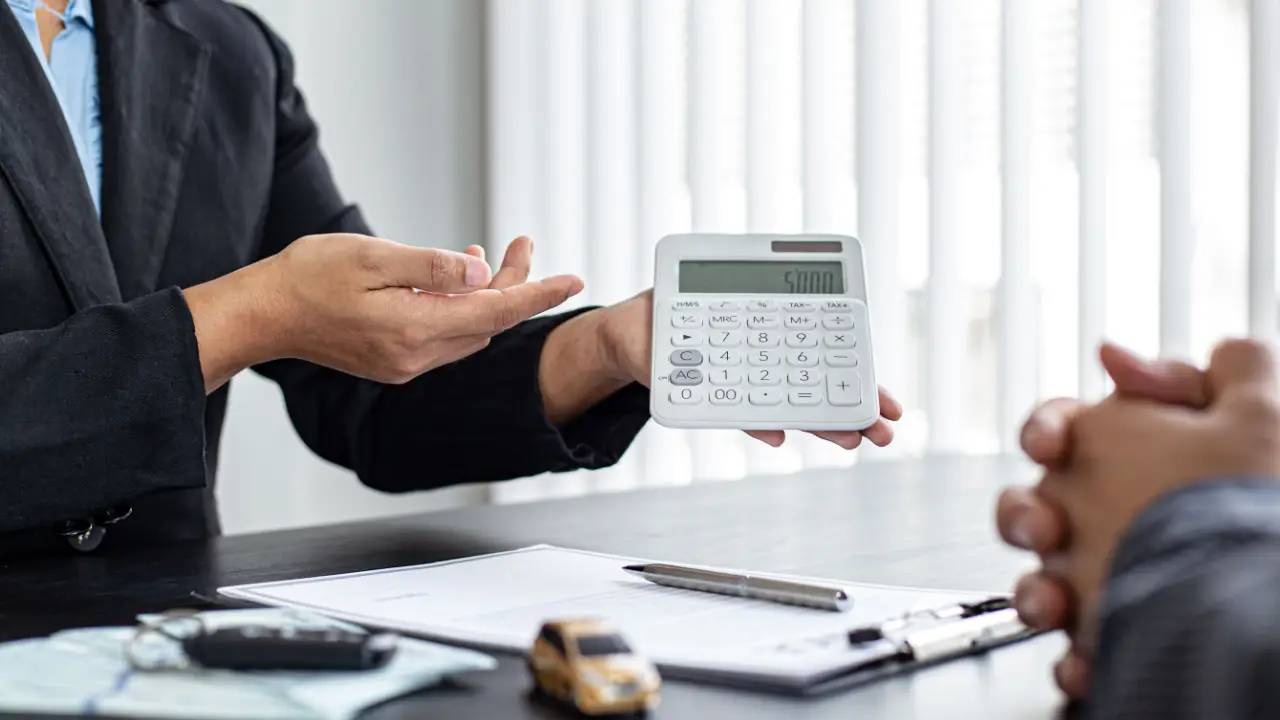 Personal injury attorney calculating what are the odds of winning a car accident lawsuit with calculator and legal documents