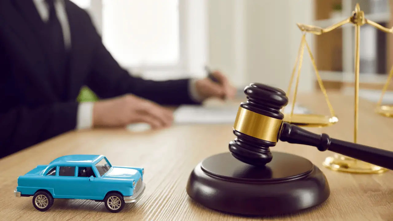Oregon car accident settlement timeline with gavel scales of justice and blue toy car representing how long you have to settle a car accident in Oregon