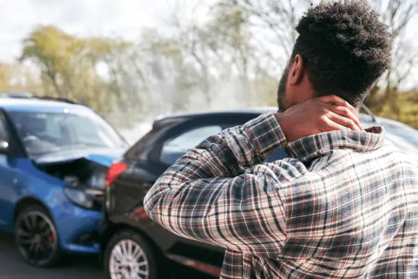 Man with neck pain after car accident wondering how long does a car accident settlement take
