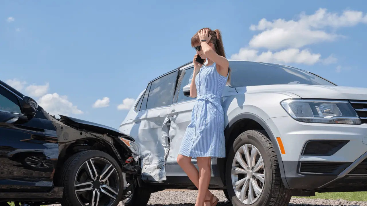 Woman on phone after car accident wondering what is the most you can sue for in a car accident