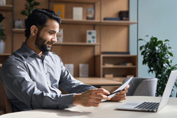 Professional man researching choosing the right car accident lawyer while reviewing documents on tablet in modern office