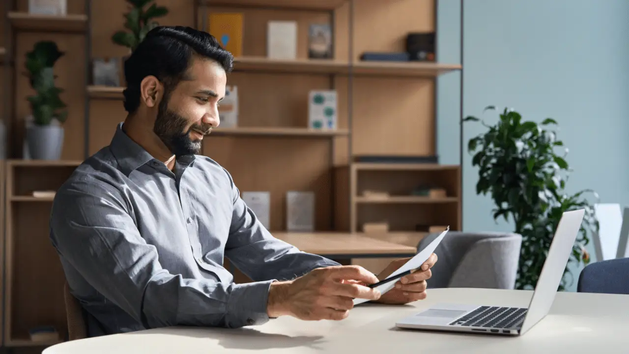 Professional man researching choosing the right car accident lawyer while reviewing documents on tablet in modern office