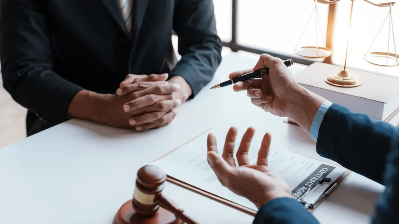 Settlement Amount Examples and Factors discussion between attorney and client with legal documents and scales of justice