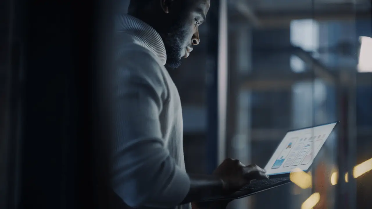 Man researching average settlement for car accident back injury on laptop with data charts