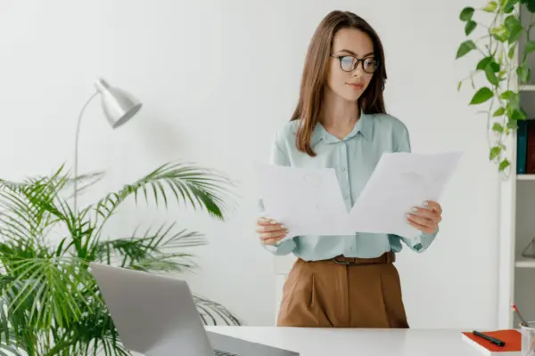 Professional woman reviewing legal documents while searching for best car accident attorney in bright modern office