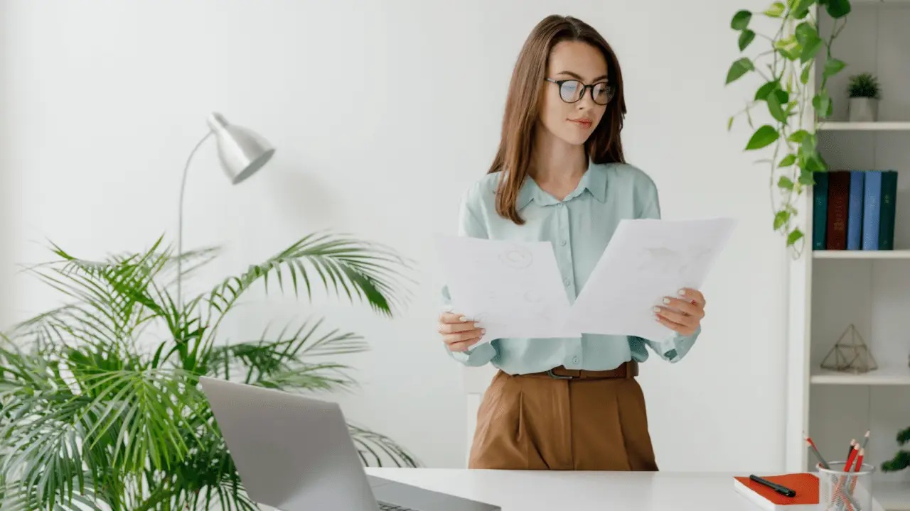 Professional woman reviewing legal documents while searching for best car accident attorney in bright modern office