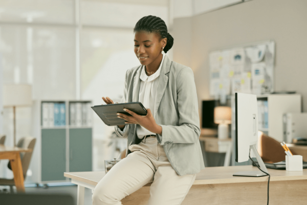 Professional woman learning how to get the most out of a car accident settlement while reviewing legal documents on tablet in modern office