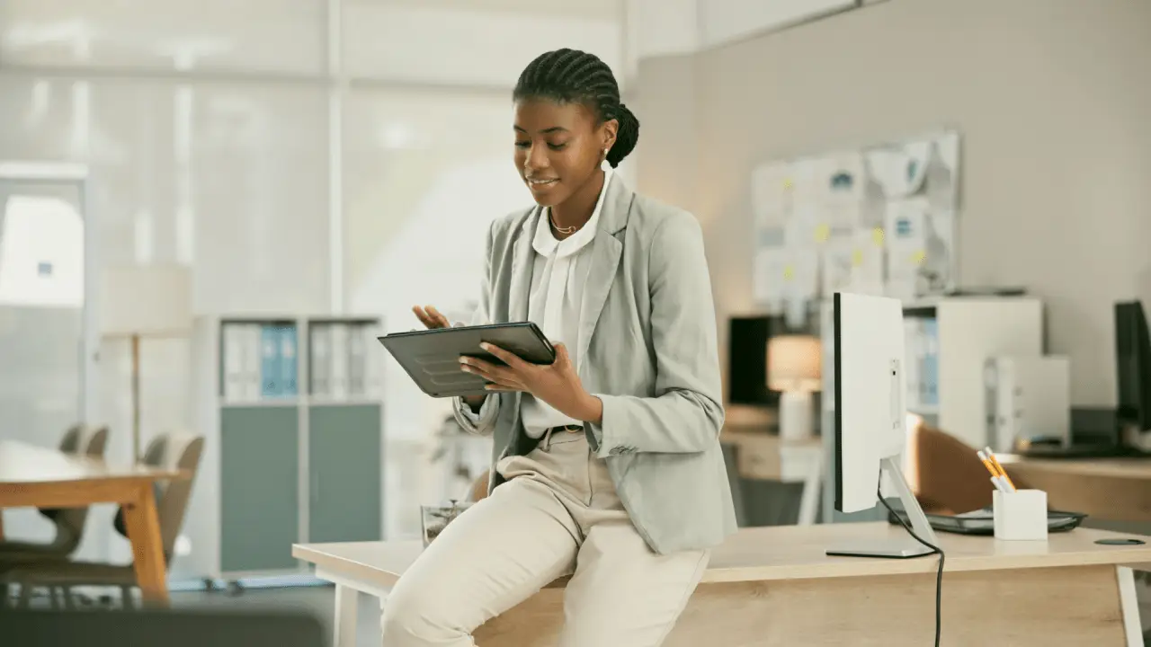 Professional woman learning how to get the most out of a car accident settlement while reviewing legal documents on tablet in modern office