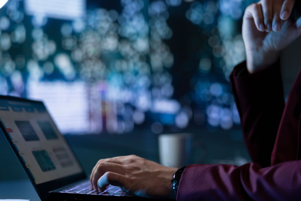 Person analyzing factors that affect car accident settlement amounts on laptop computer