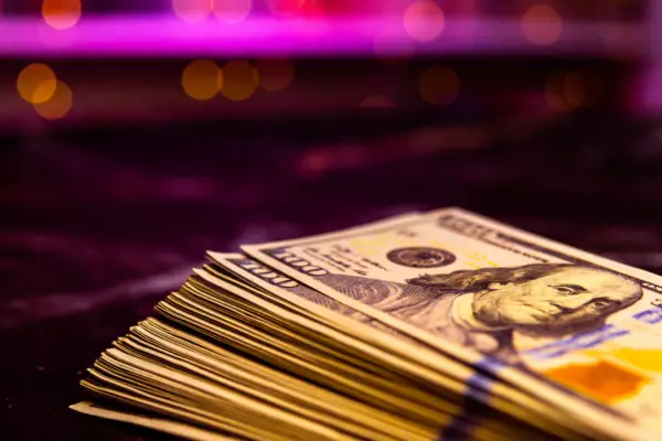 Stack of hundred dollar bills representing what is a reasonable settlement offer compensation