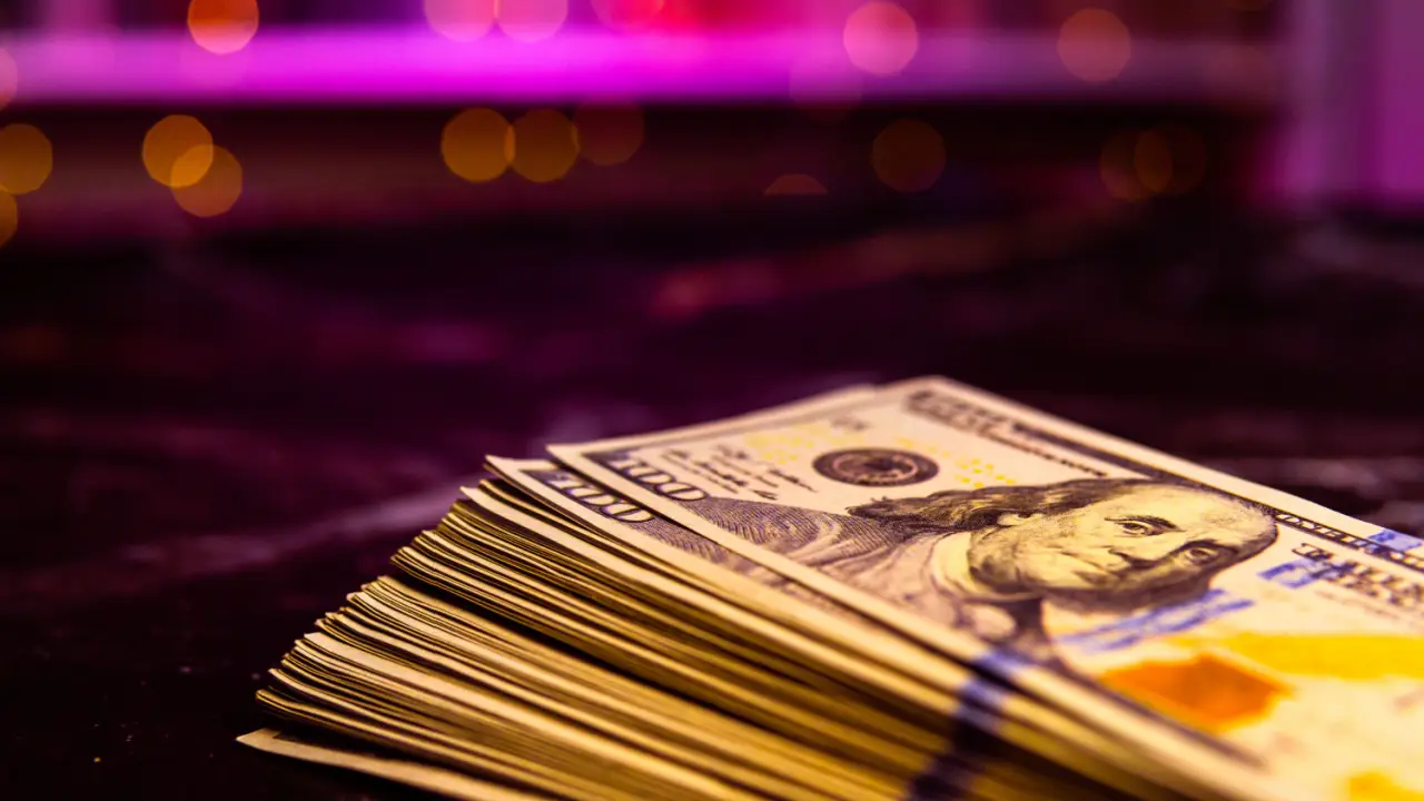 Stack of hundred dollar bills representing what is a reasonable settlement offer compensation