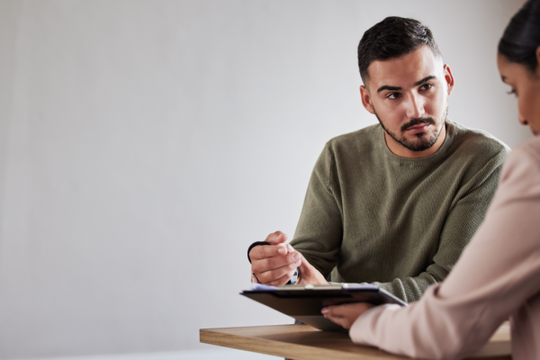 Personal injury lawyer car accident consultation with attorney taking detailed notes during client meeting