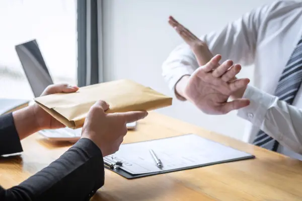 Professional refusing settlement documents demonstrating what not to say to an injury lawyer consultation