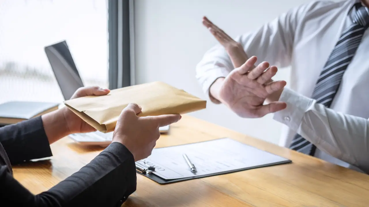 Professional refusing settlement documents demonstrating what not to say to an injury lawyer consultation