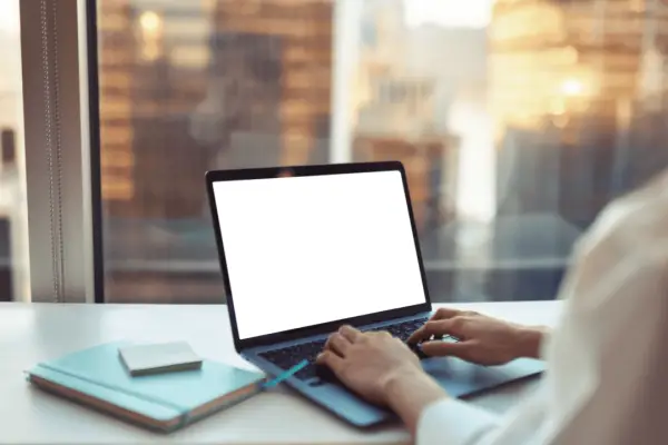 Person researching how much should I ask for a settlement on laptop computer