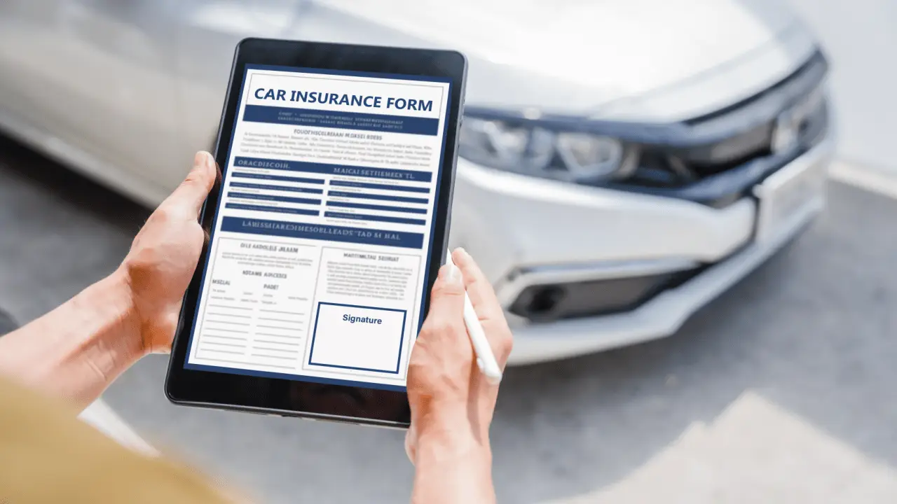 Person reviewing car insurance form on tablet with vehicle in background - what happens if someone sues you for more than your insurance covers