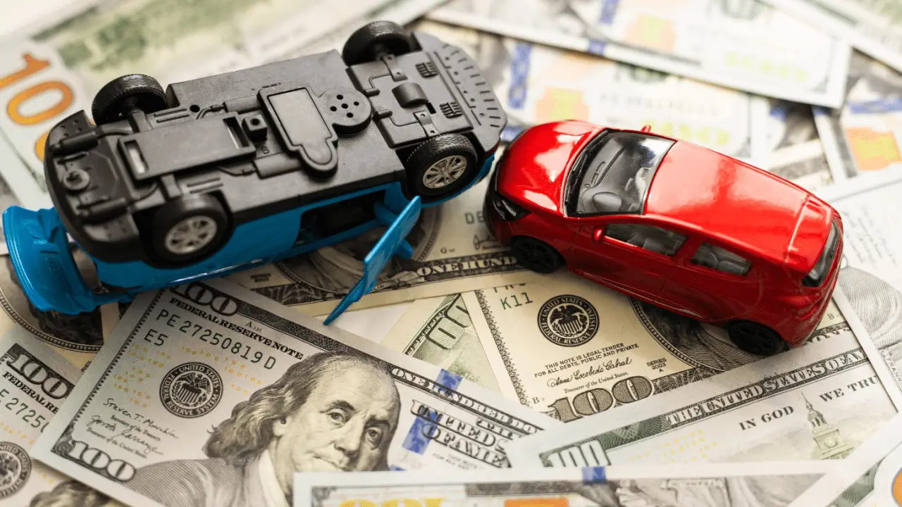 Car accident lawsuit money damages with toy cars and cash representing what is the maximum you can sue for a car accident