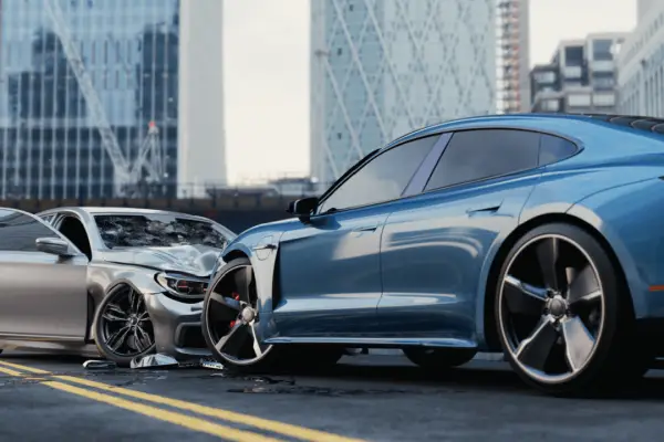 Two damaged cars after collision showing who pays the settlement in a car accident scenario