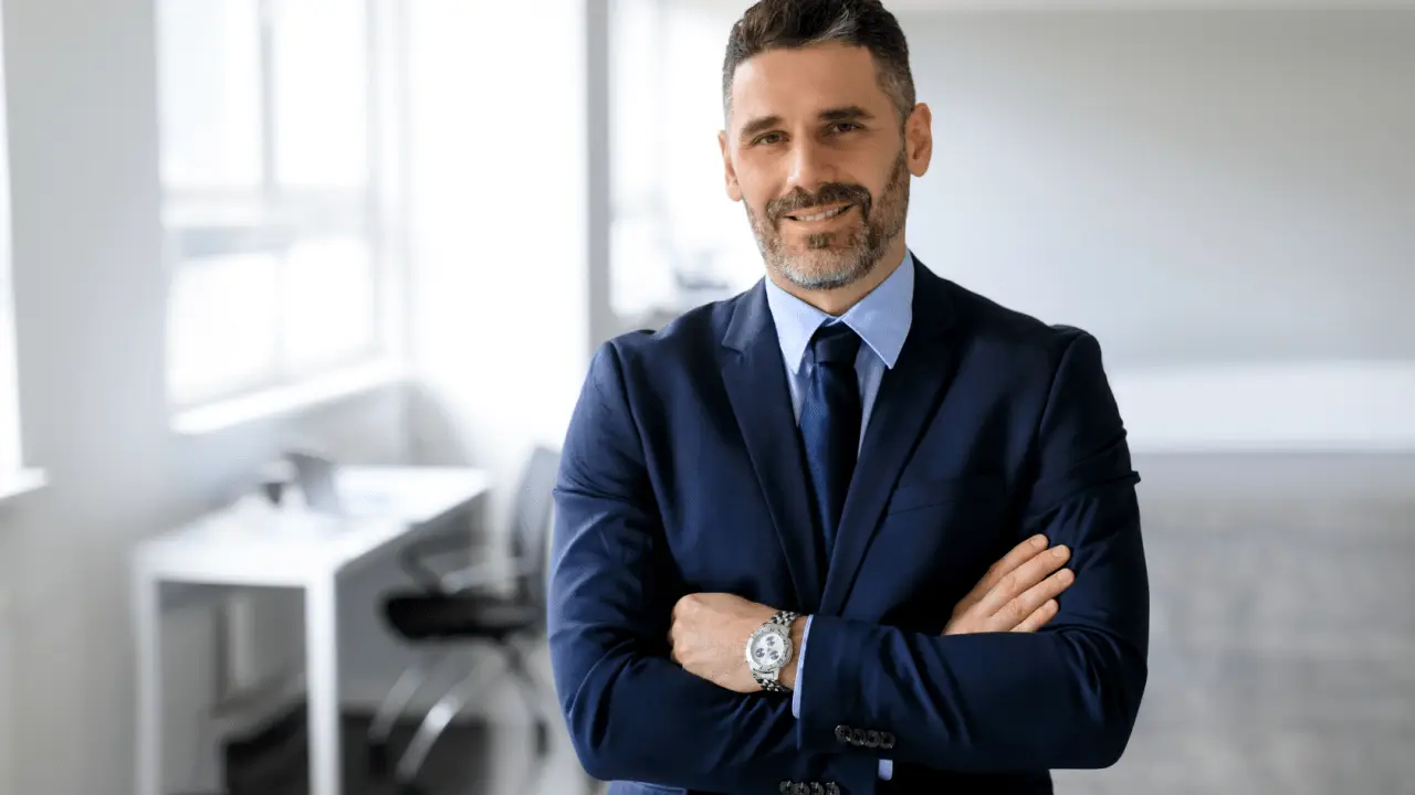 Professional motorcycle accident lawyer in navy suit standing confidently in modern office