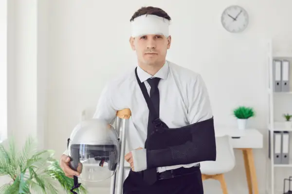 Injured motorcycle accident victim with arm sling and head bandage considering what is the average payout for a motorcycle accident settlement