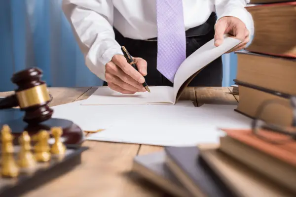 Injury lawyer reviewing contingency fee agreement showing what percent does an injury lawyer take from settlement