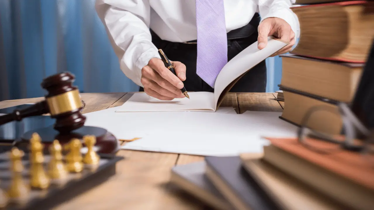 Injury lawyer reviewing contingency fee agreement showing what percent does an injury lawyer take from settlement