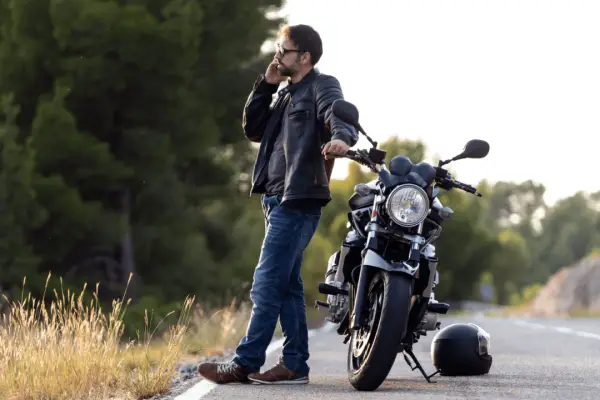 Motorcyclist calling for help after crash wondering when do you need a motorcycle accident lawyer