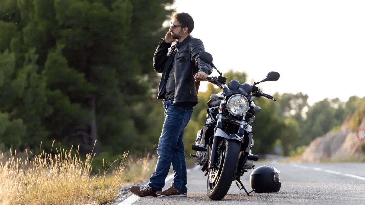 Motorcyclist calling for help after crash wondering when do you need a motorcycle accident lawyer