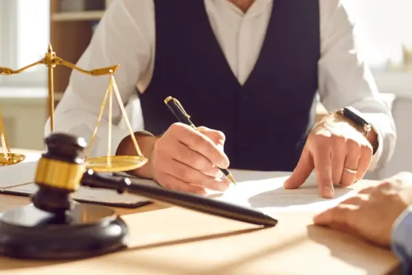 Professional lawyer reviewing documents with client discussing when to hire a motorcycle accident lawyer